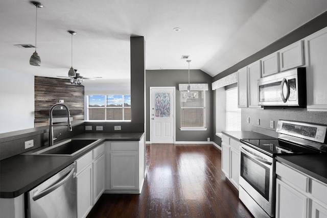 kitchen with white cabinetry, sink, pendant lighting, and stainless steel appliances