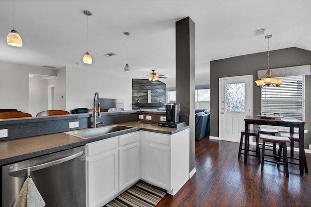 kitchen featuring ceiling fan with notable chandelier, pendant lighting, sink, white cabinets, and stainless steel dishwasher