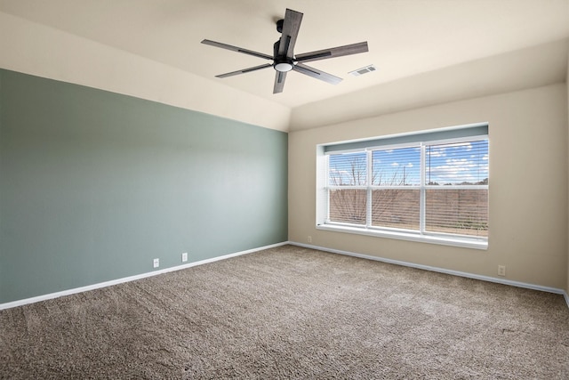 carpeted spare room with ceiling fan and lofted ceiling