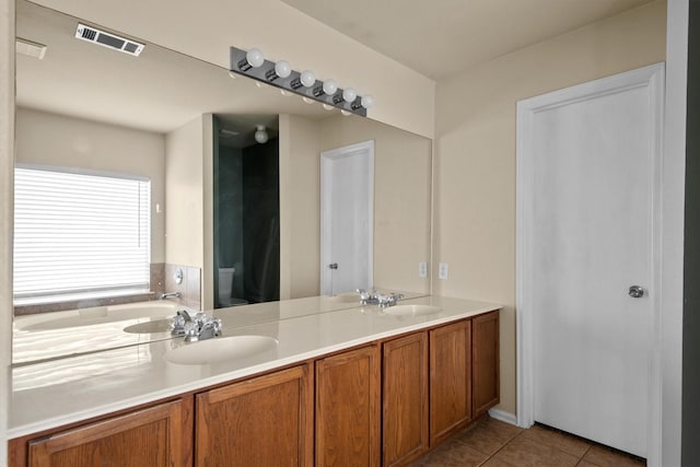 bathroom featuring tile patterned flooring, vanity, and toilet