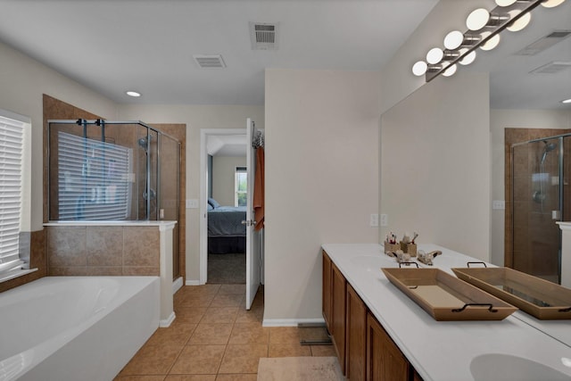 bathroom with tile patterned floors, shower with separate bathtub, and vanity