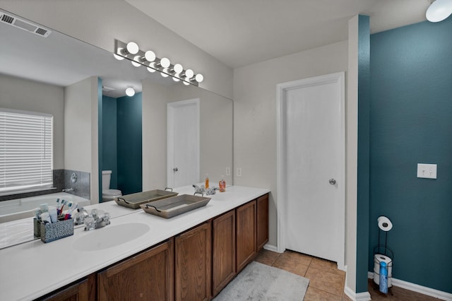 bathroom featuring vanity, toilet, and tile patterned flooring