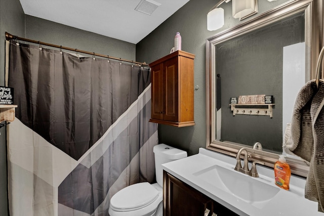 bathroom featuring vanity, a shower with shower curtain, and toilet