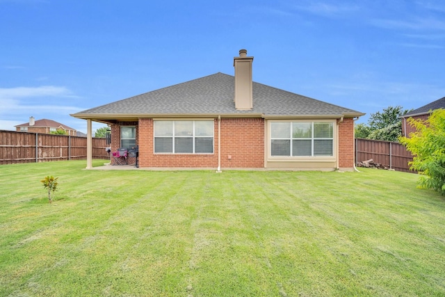 back of property with a yard and a patio