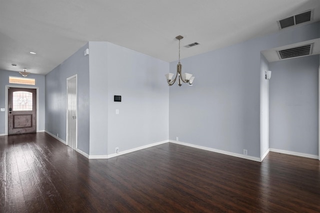 interior space featuring an inviting chandelier and dark hardwood / wood-style flooring