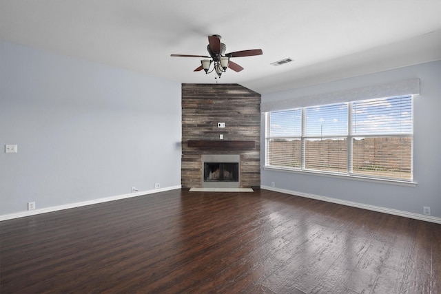 unfurnished living room featuring ceiling fan, lofted ceiling, a large fireplace, and dark hardwood / wood-style floors