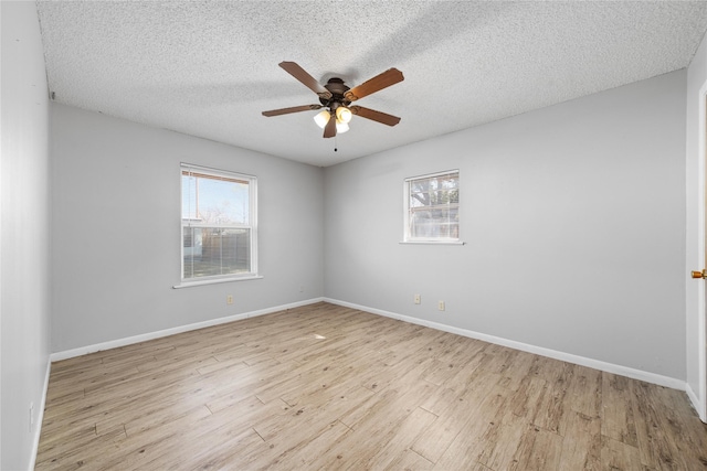 spare room with ceiling fan, a textured ceiling, and light hardwood / wood-style floors