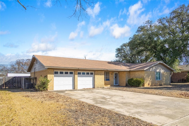 ranch-style home with a garage and cooling unit