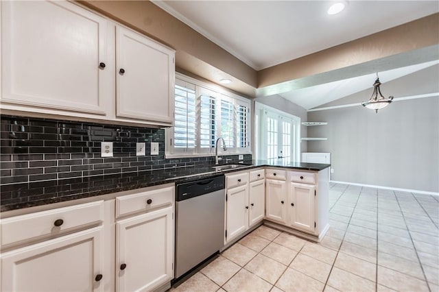 kitchen featuring hanging light fixtures, white cabinets, dishwasher, and lofted ceiling