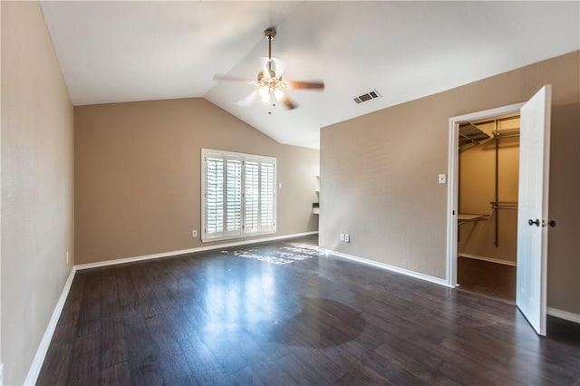 empty room with ceiling fan, dark hardwood / wood-style flooring, and lofted ceiling