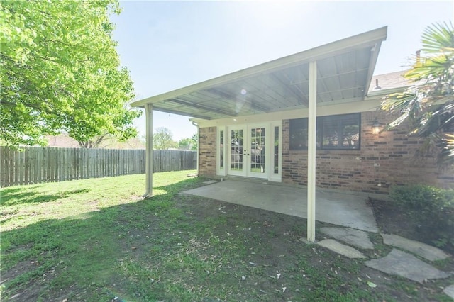 view of yard featuring a patio area and french doors