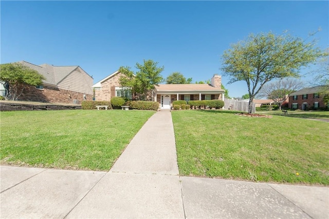 ranch-style house with a front lawn and covered porch