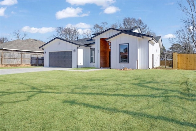 view of front of house with a garage and a front lawn