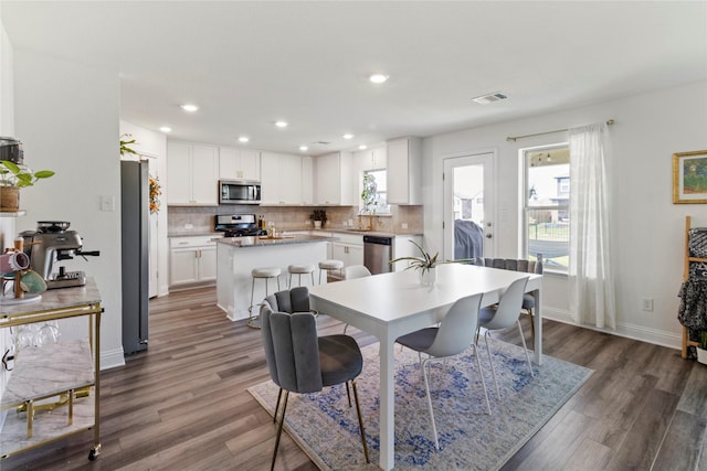 dining area with dark hardwood / wood-style flooring and sink