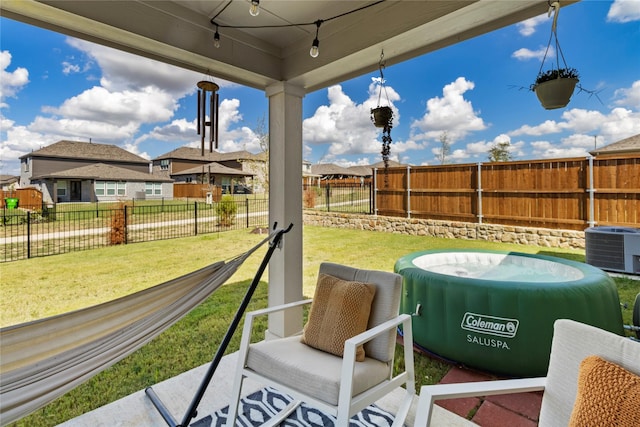 view of patio featuring a jacuzzi and central AC unit