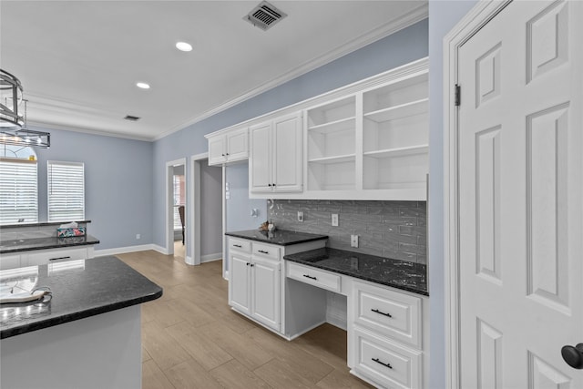 kitchen with white cabinetry, pendant lighting, light hardwood / wood-style floors, and tasteful backsplash