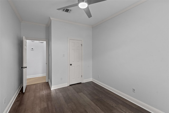 unfurnished bedroom with ceiling fan, a closet, dark hardwood / wood-style flooring, and ornamental molding