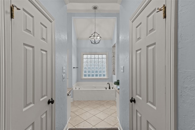 bathroom featuring a bath, an inviting chandelier, tile patterned flooring, and ornamental molding