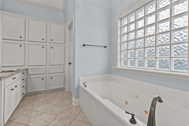 bathroom with vanity, tile patterned flooring, and a relaxing tiled tub