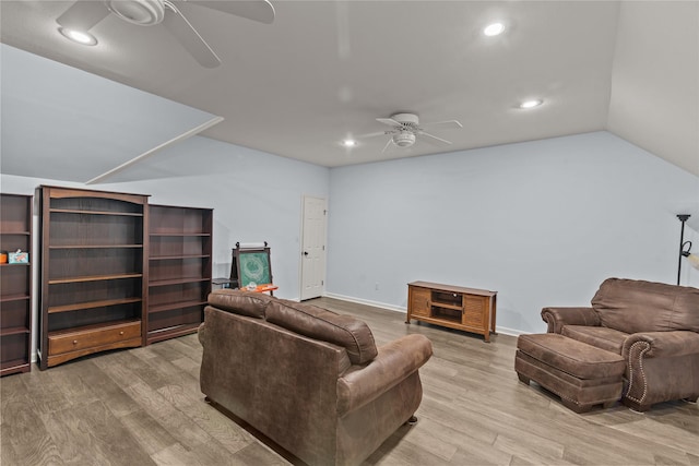 living room featuring ceiling fan, vaulted ceiling, and light hardwood / wood-style floors