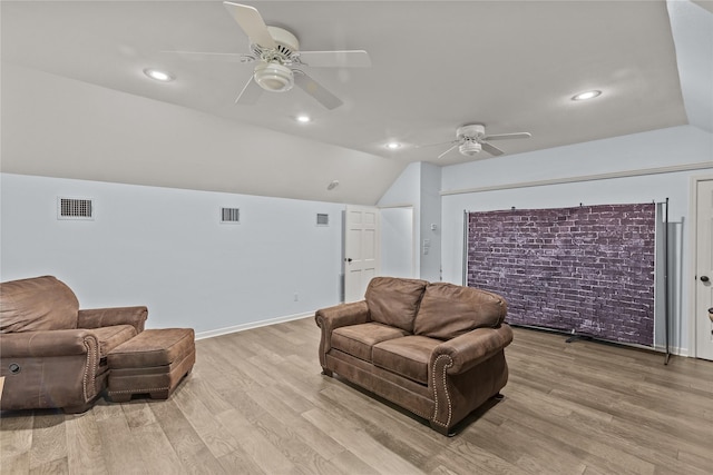 living room with ceiling fan, light wood-type flooring, and vaulted ceiling