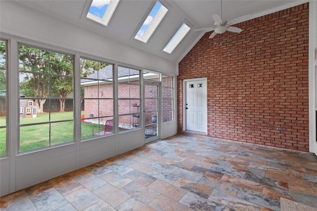 unfurnished sunroom featuring lofted ceiling, ceiling fan, and a healthy amount of sunlight