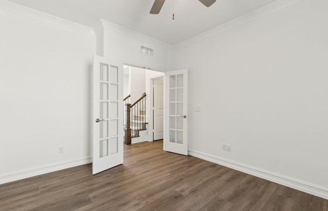 unfurnished room featuring dark wood-style floors, french doors, ornamental molding, and baseboards