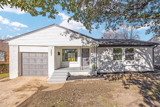 view of front of house featuring covered porch and a garage