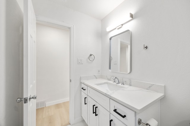 bathroom with hardwood / wood-style floors and vanity