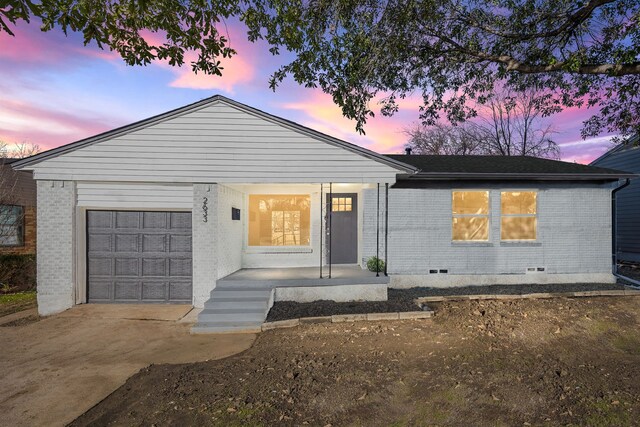 view of front of property with a garage and a porch