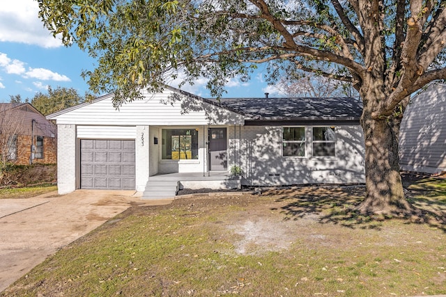 single story home featuring a garage and a front yard