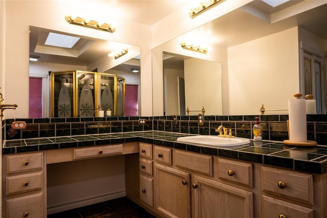 bathroom with walk in shower, vanity, tile patterned flooring, decorative backsplash, and a skylight