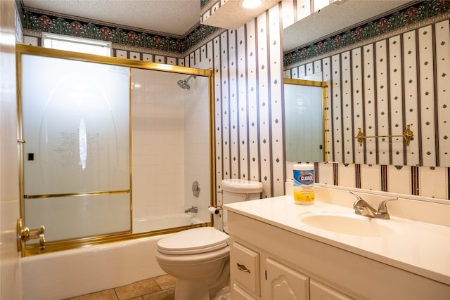 full bathroom with toilet, vanity, tile patterned flooring, enclosed tub / shower combo, and a textured ceiling