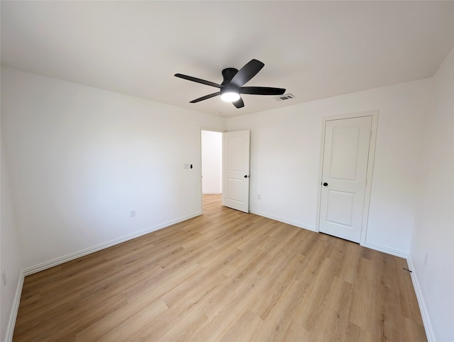 unfurnished bedroom with ceiling fan, light wood-style flooring, visible vents, and baseboards