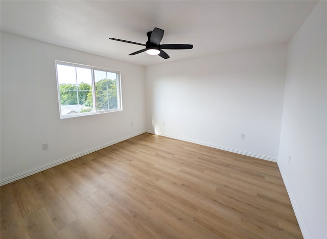 unfurnished room with light wood finished floors, ceiling fan, and baseboards