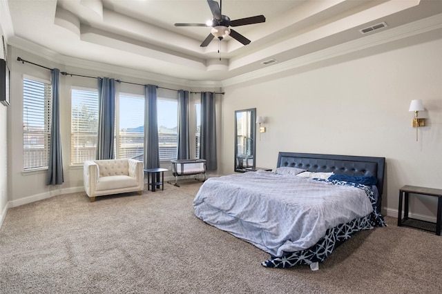 bedroom featuring a raised ceiling, ornamental molding, carpet flooring, and ceiling fan