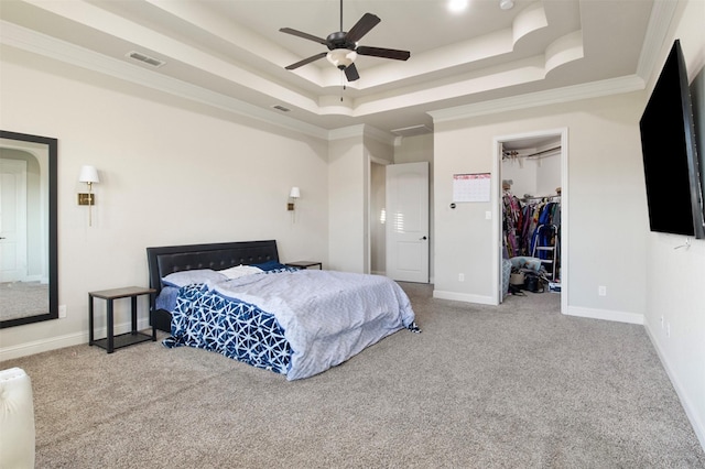 bedroom featuring crown molding, ceiling fan, a raised ceiling, a spacious closet, and a closet