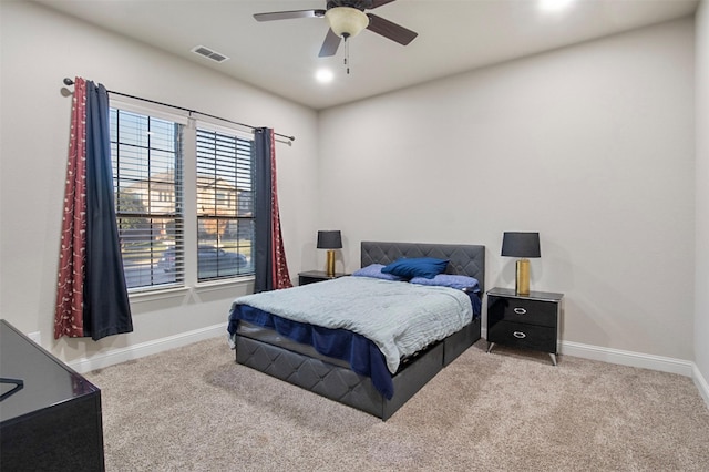 bedroom featuring light carpet and ceiling fan