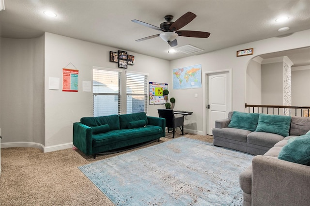 carpeted living room featuring ceiling fan