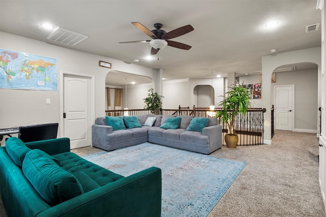 carpeted living room featuring ceiling fan