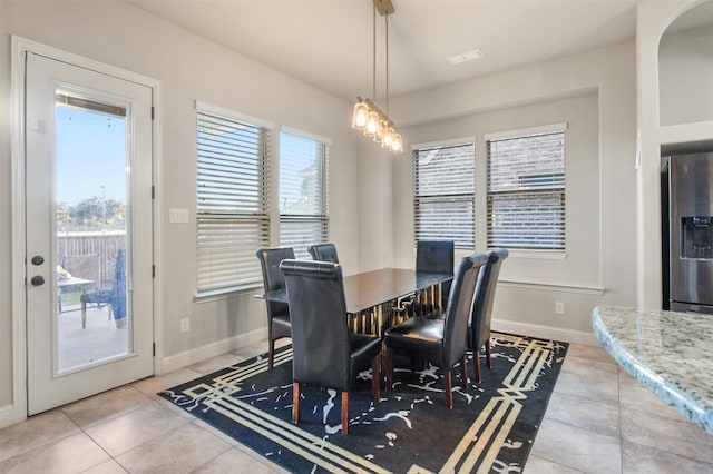 tiled dining space with a wealth of natural light