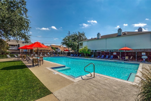 view of swimming pool with a lawn and a patio