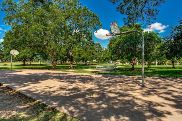 surrounding community with a yard and basketball hoop