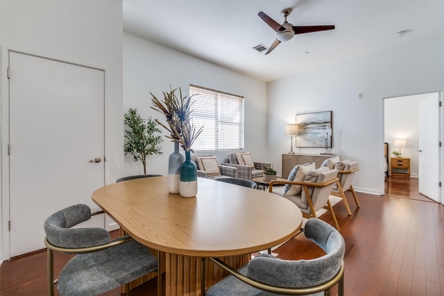 dining area with ceiling fan and dark hardwood / wood-style flooring