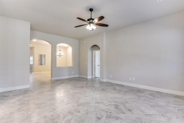 unfurnished room with ceiling fan with notable chandelier