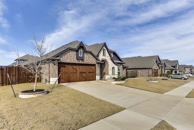 view of front of home featuring a garage and a front lawn