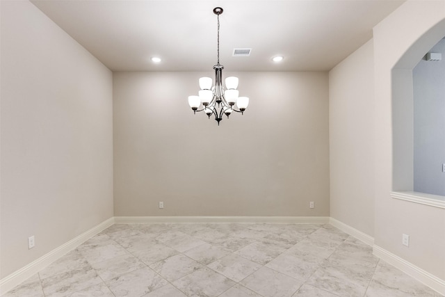 spare room with an inviting chandelier