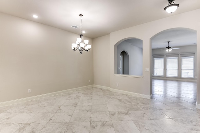 empty room featuring ceiling fan with notable chandelier