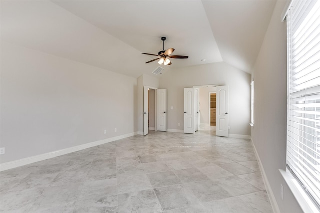 empty room featuring ceiling fan and vaulted ceiling