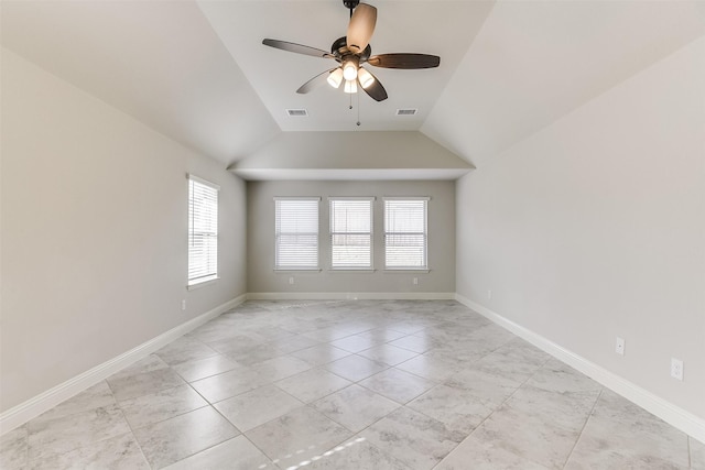 tiled spare room with ceiling fan and vaulted ceiling